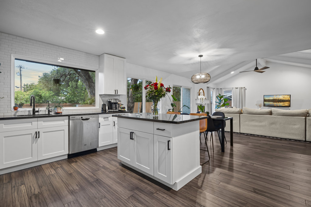 9308 Meadowheath Drive Austin, TX 78729 - Photo 15 of 40 a kitchen with counter top space and wooden floor