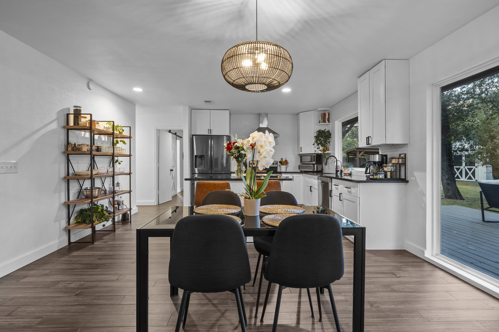 9308 Meadowheath Drive Austin, TX 78729 - Photo 18 of 40 a view of a dining room with furniture and wooden floor