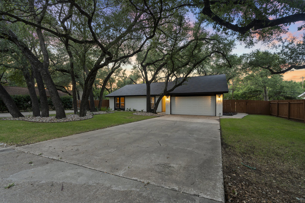 9308 Meadowheath Drive Austin, TX 78729 - Photo 2 of 40 a front view of a house with a yard and garage