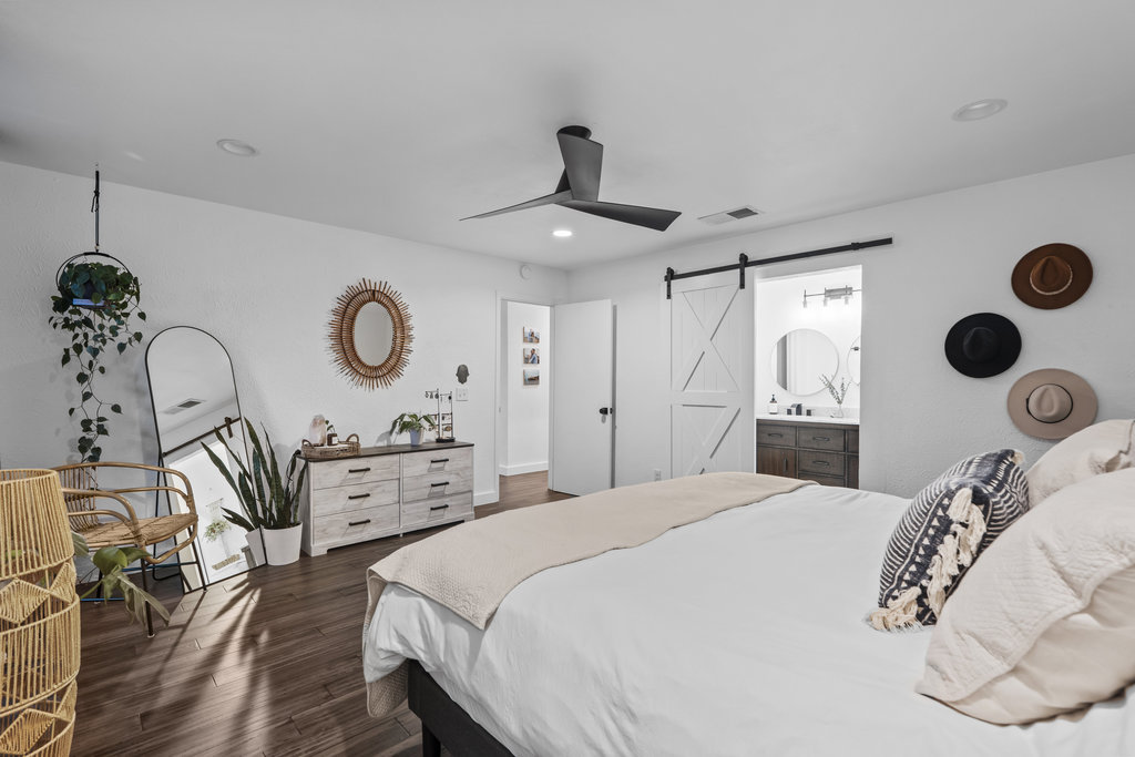 9308 Meadowheath Drive Austin, TX 78729 - Photo 22 of 40 a bedroom with a bed and cabinets