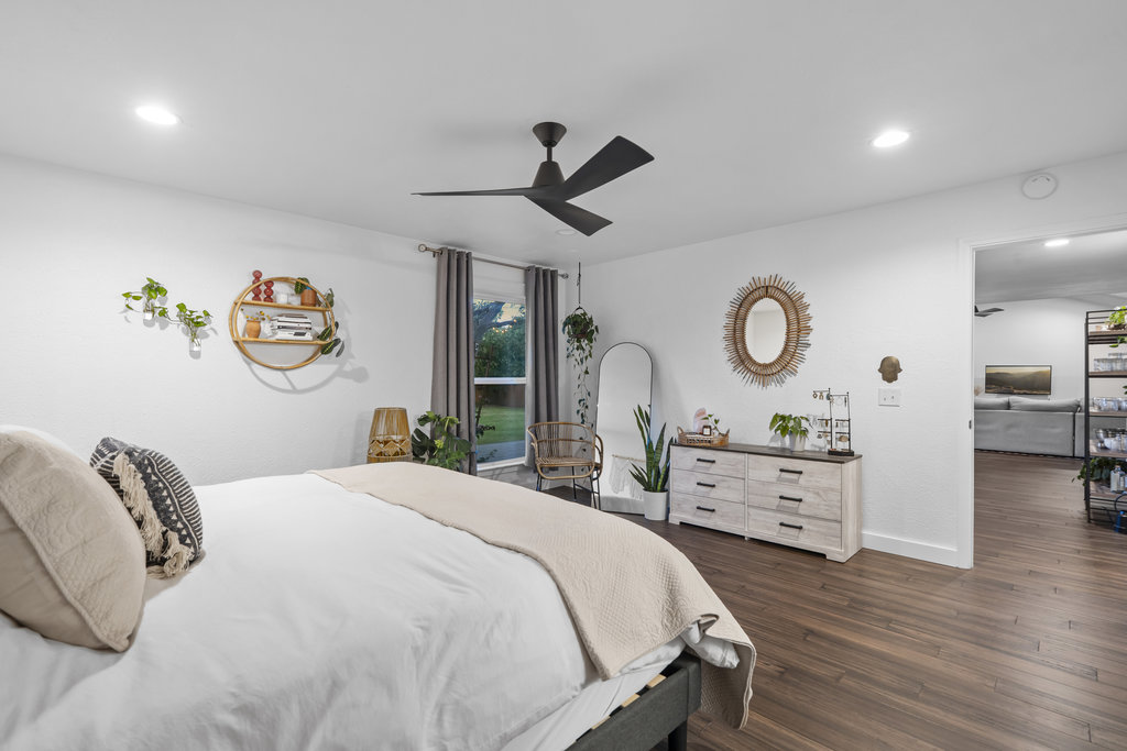 9308 Meadowheath Drive Austin, TX 78729 - Photo 23 of 40 a bedroom with a bed and wooden floor