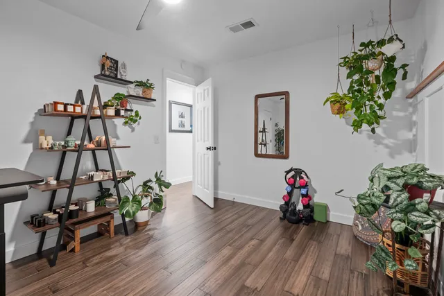 a view of a workspace with furniture and wooden floor