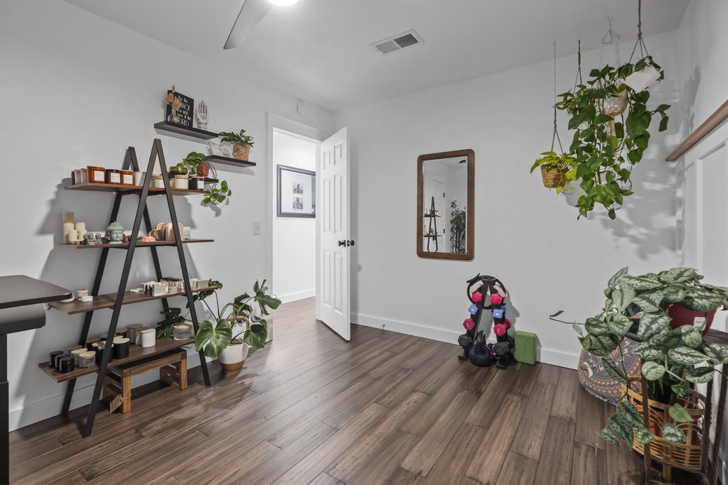 9308 Meadowheath Drive Austin, TX 78729 - Photo 28 of 40 a view of a workspace with furniture and wooden floor
