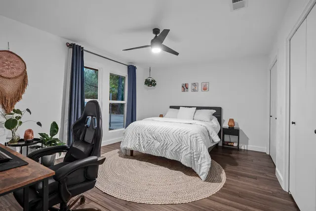 a bedroom with a bed and wooden floor