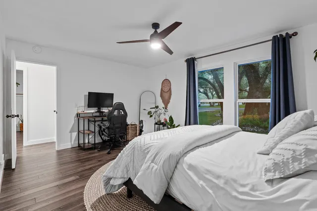 a bedroom with a bed and a flat screen tv