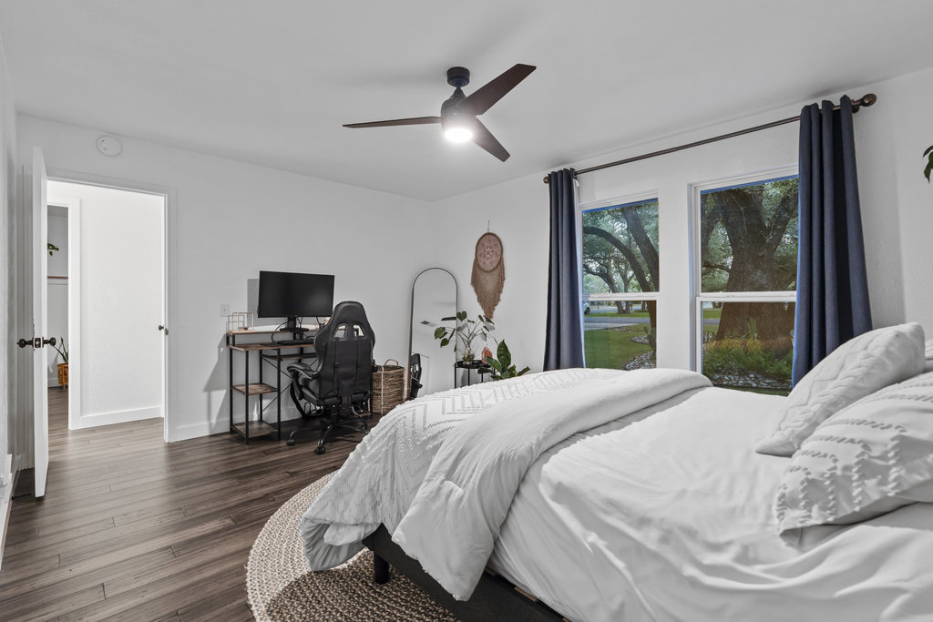 9308 Meadowheath Drive Austin, TX 78729 - Photo 30 of 40 a bedroom with a bed and a flat screen tv