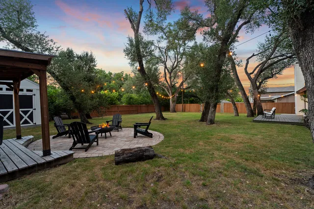 a swimming pool with outdoor seating and garden
