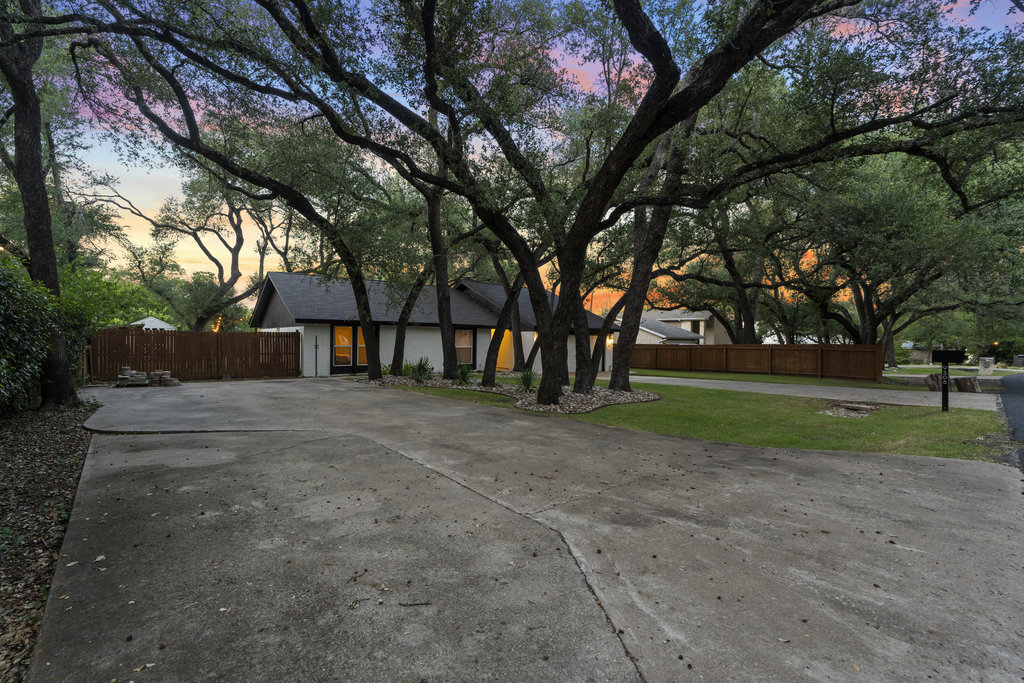 9308 Meadowheath Drive Austin, TX 78729 - Photo 4 of 40 a view of road with large trees