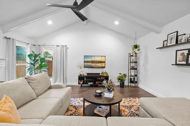 a living room with furniture and wooden floor