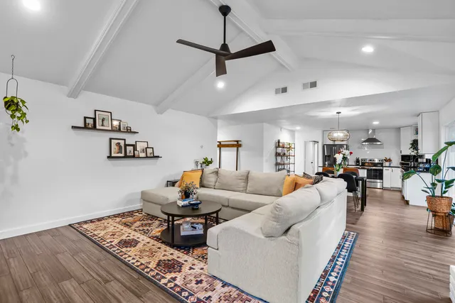 a living room with furniture and wooden floor