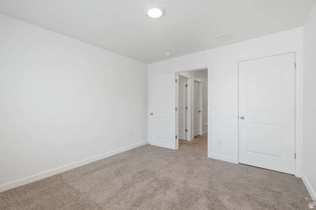 3788 South Galatia Road Magna, UT 84044 - Photo 17 of 24 Room featuring neutral carpet flooring, white walls, white baseboards, and a flush-mount ceiling light