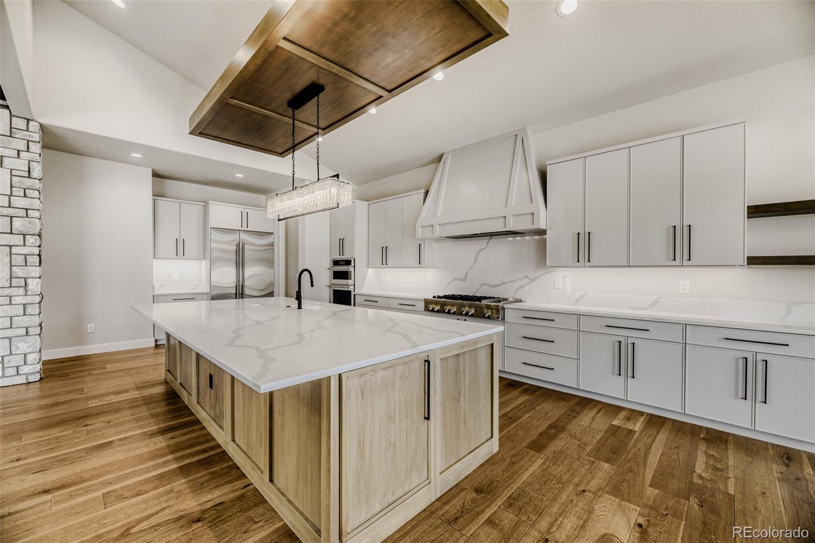 5796 Powell Road Parker, CO 80134 - Photo 14 of 50 a kitchen with stainless steel appliances granite countertop a stove a sink dishwasher and a refrigerator