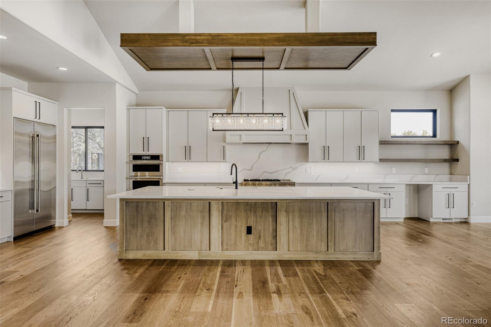 5796 Powell Road Parker, CO 80134 - Photo 15 of 50 a kitchen with stainless steel appliances a sink and cabinets