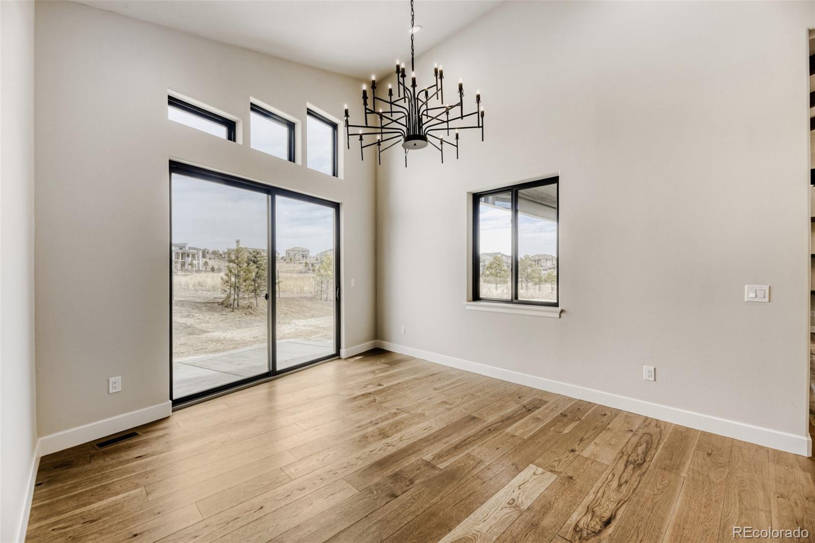 5796 Powell Road Parker, CO 80134 - Photo 19 of 50 a view of an empty room with window and wooden floor