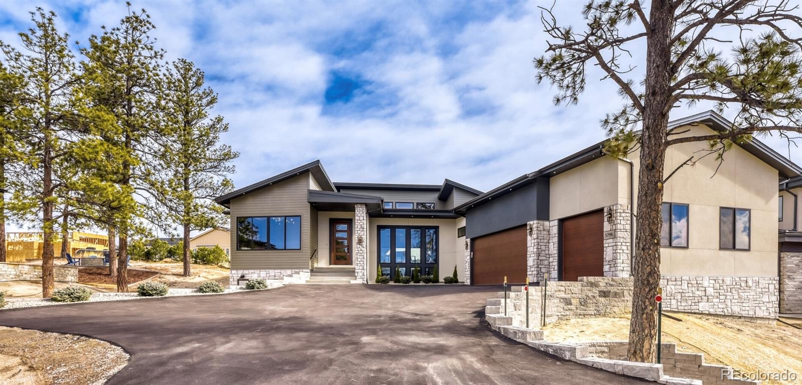 5796 Powell Road Parker, CO 80134 - Photo 2 of 50 a front view of a house with a tree in it