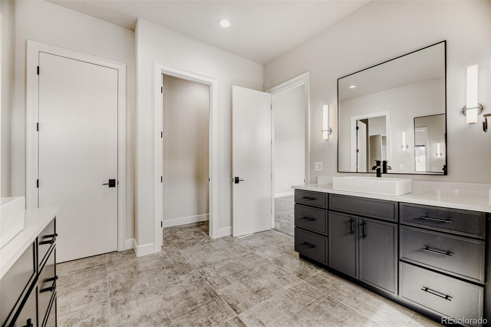 5796 Powell Road Parker, CO 80134 - Photo 26 of 50 a bathroom with a sink and a mirror