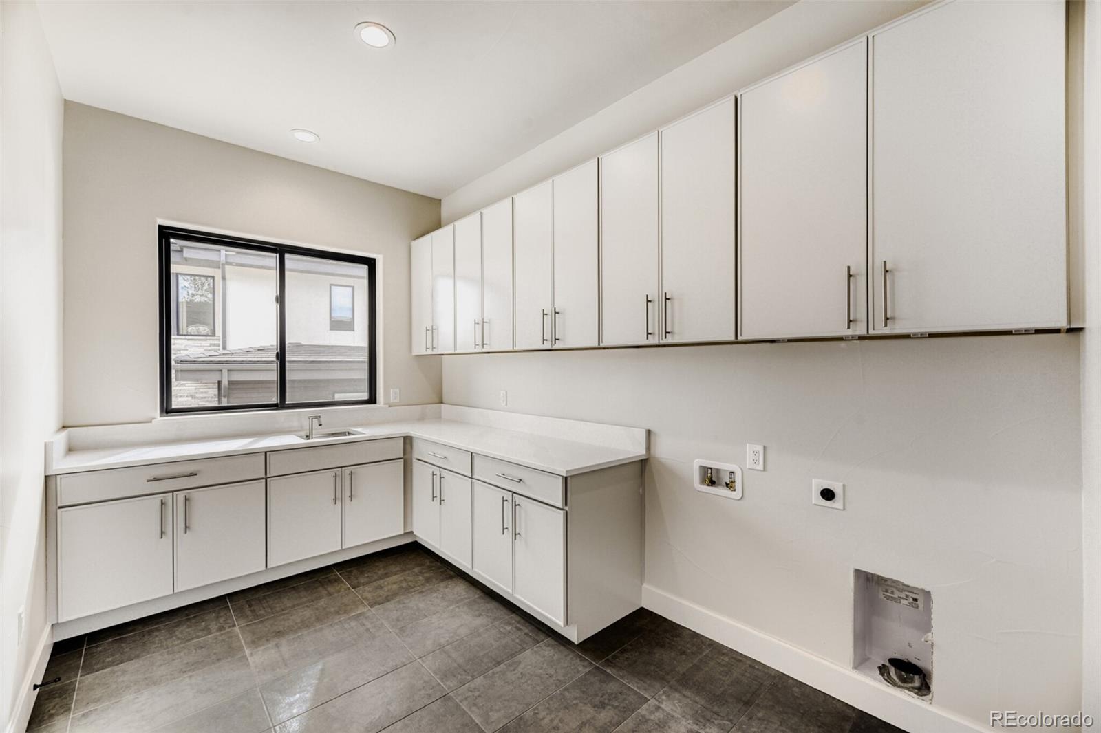 5796 Powell Road Parker, CO 80134 - Photo 29 of 50 a kitchen with white cabinets and sink