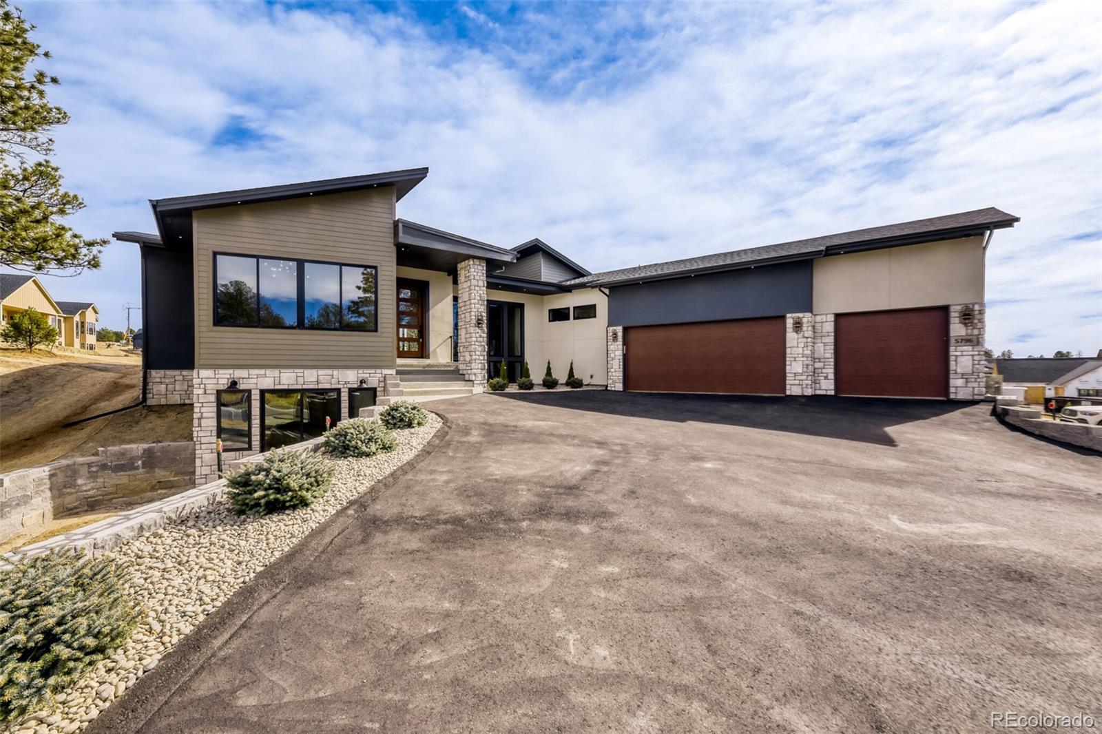 5796 Powell Road Parker, CO 80134 - Photo 3 of 50 a front view of a house with a yard