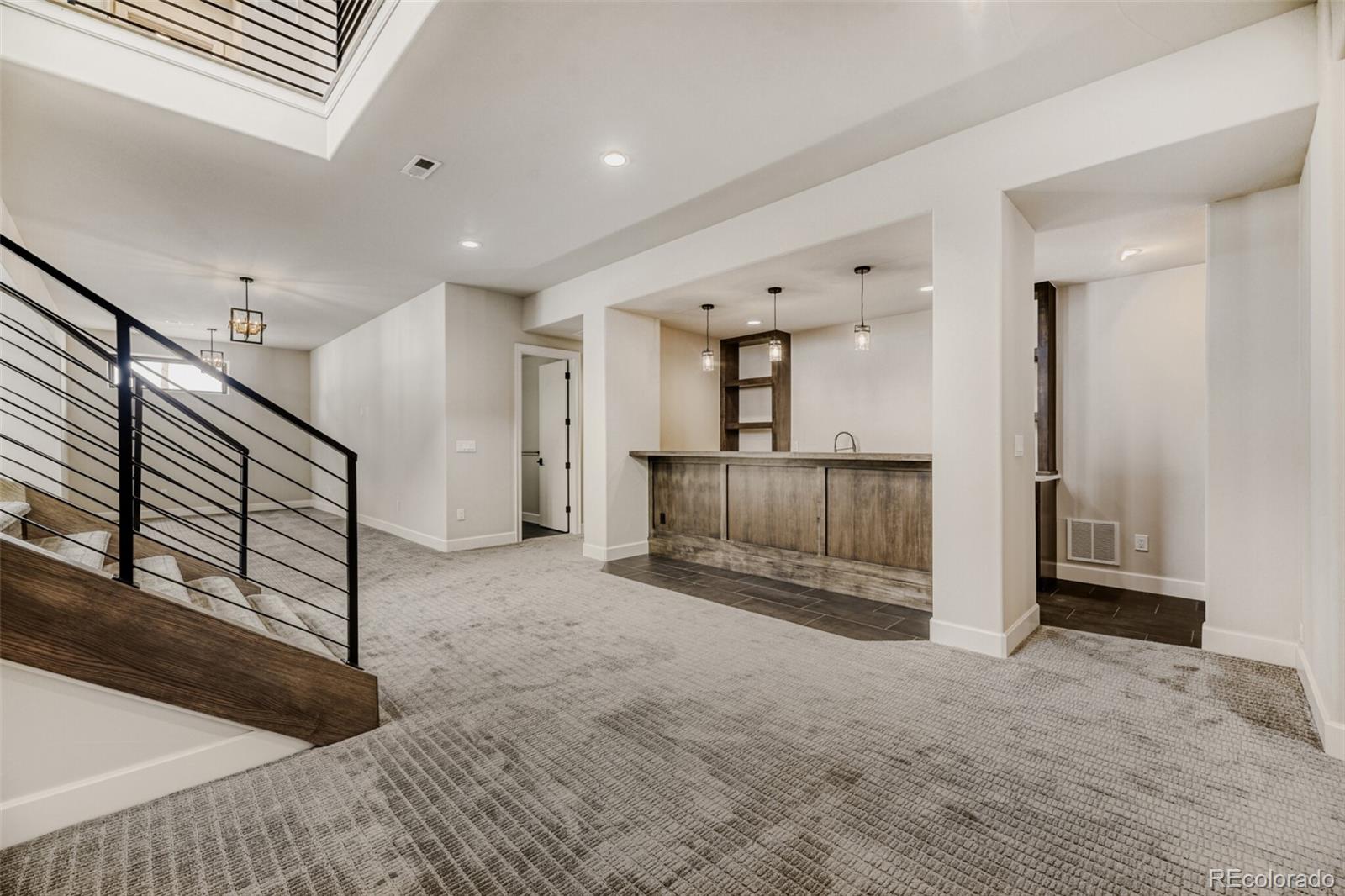 5796 Powell Road Parker, CO 80134 - Photo 31 of 50 a view of a hallway with entryway and stairs