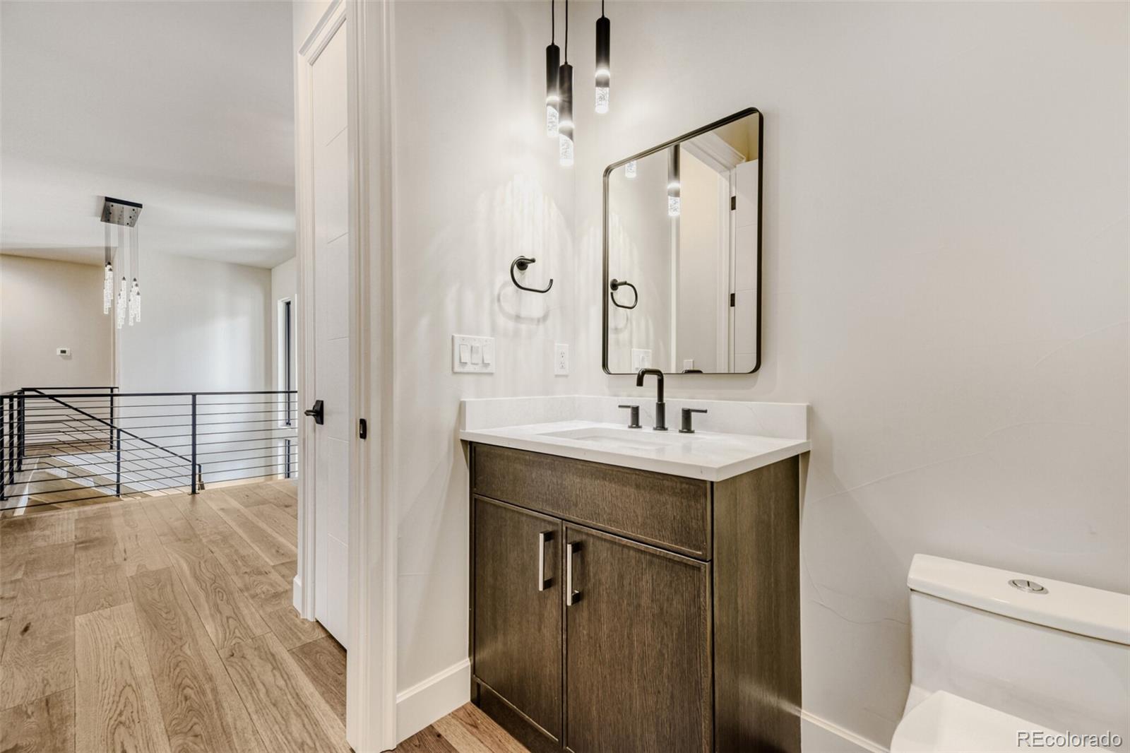 5796 Powell Road Parker, CO 80134 - Photo 36 of 50 a bathroom with a sink a toilet and mirror