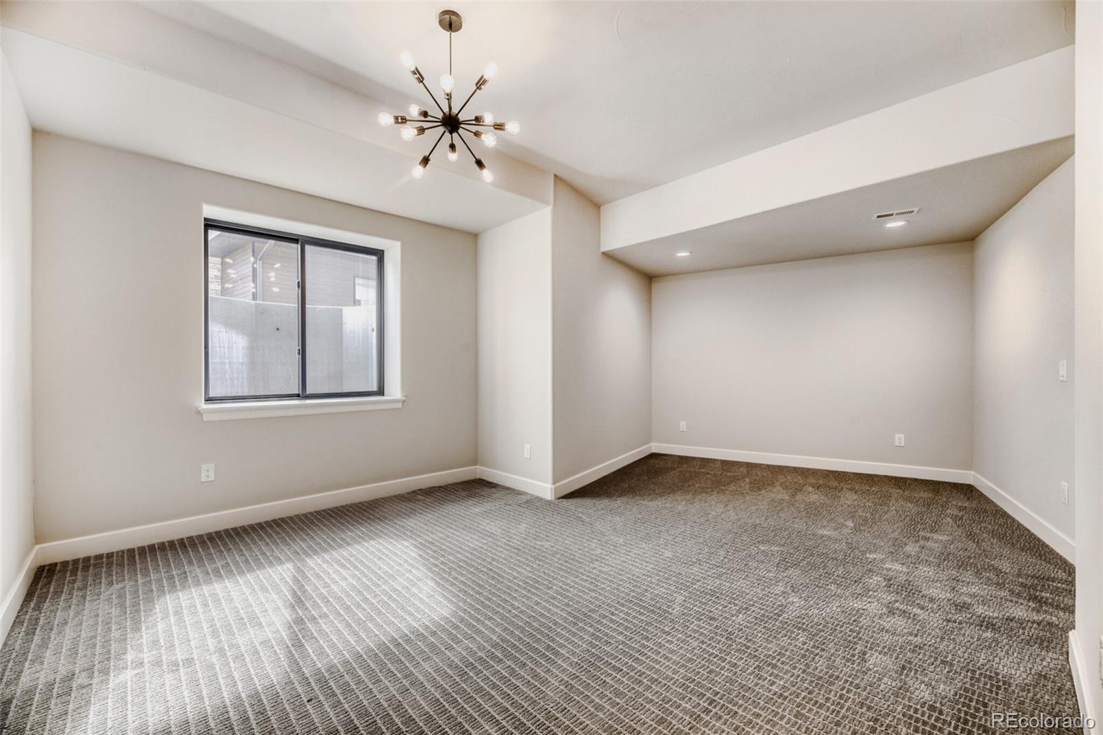 5796 Powell Road Parker, CO 80134 - Photo 40 of 50 a view of an empty room with a window and wooden floor