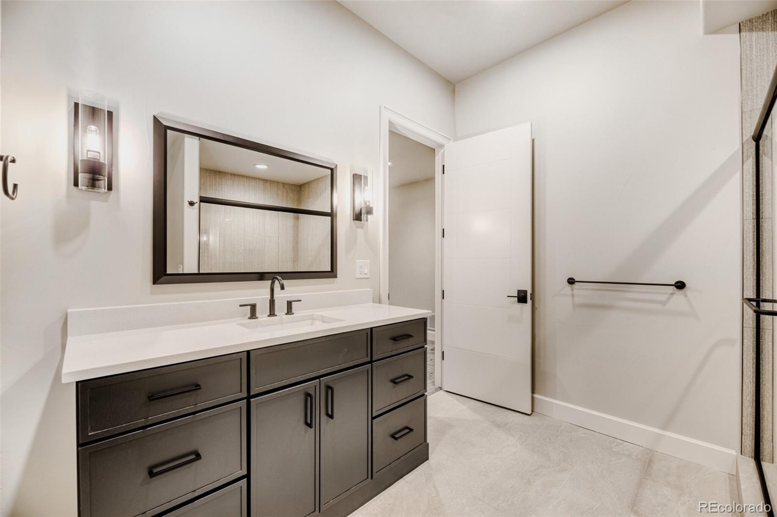 5796 Powell Road Parker, CO 80134 - Photo 44 of 50 a bathroom with a sink and a mirror