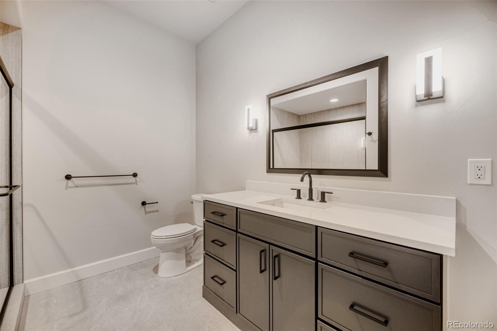 5796 Powell Road Parker, CO 80134 - Photo 45 of 50 a bathroom with a toilet sink and mirror
