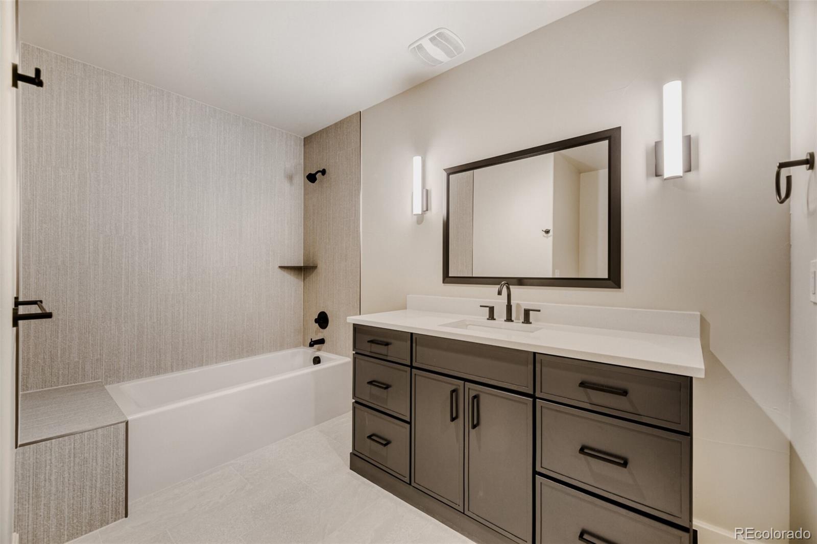5796 Powell Road Parker, CO 80134 - Photo 46 of 50 a bathroom with a tub sink and mirror
