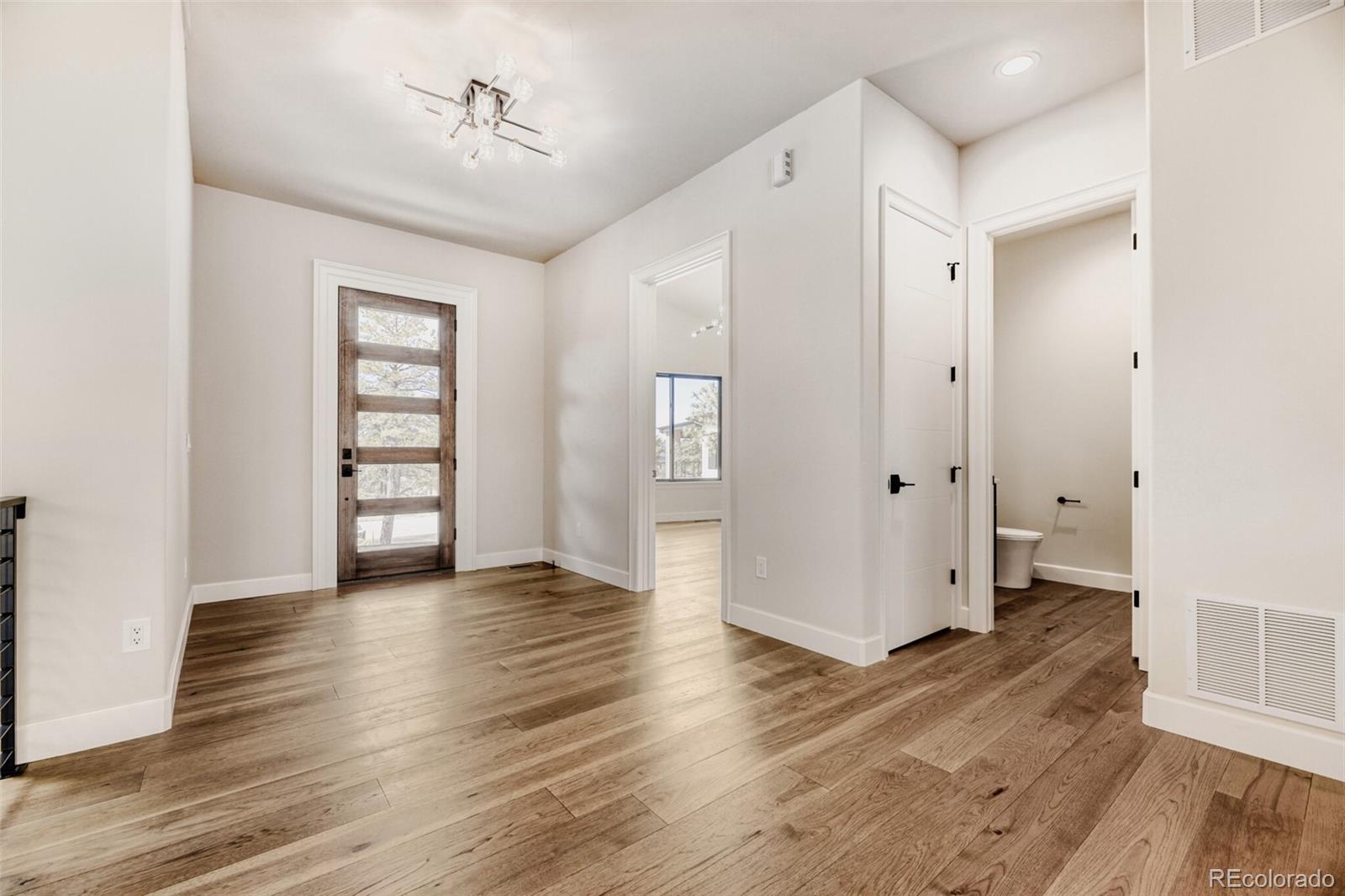 5796 Powell Road Parker, CO 80134 - Photo 6 of 50 an empty room with wooden floor and closet