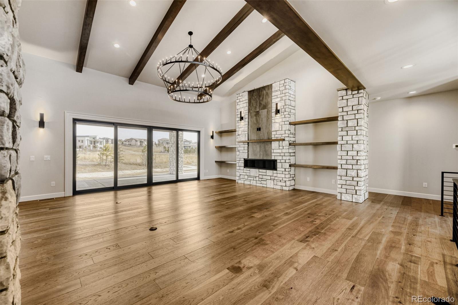 5796 Powell Road Parker, CO 80134 - Photo 9 of 50 a view of an empty room with a window and wooden floor