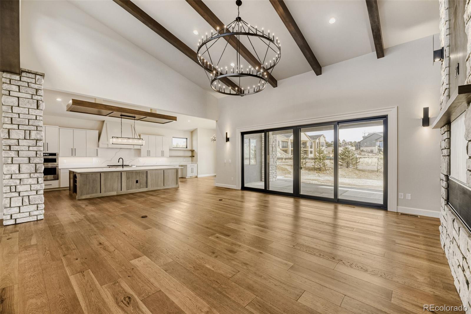 5796 Powell Road Parker, CO 80134 - Photo 10 of 50 a view of an empty room with window and wooden floor