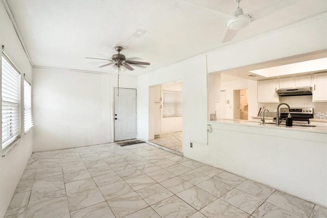 830 Southwest 50th Avenue Margate, FL 33068 - Photo 14 of 30 a view of a livingroom with a chandelier fan and windows