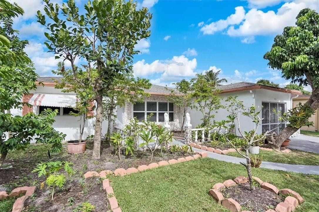 830 Southwest 50th Avenue Margate, FL 33068 - Photo 2 of 30 a front view of a house with a yard