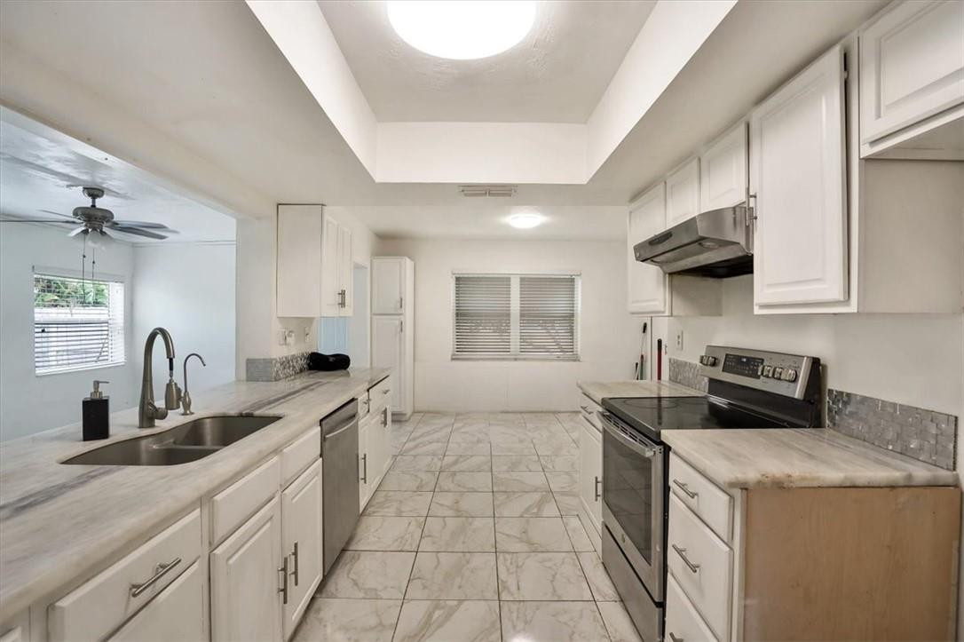 830 Southwest 50th Avenue Margate, FL 33068 - Photo 6 of 30 a kitchen that has a sink and a stove