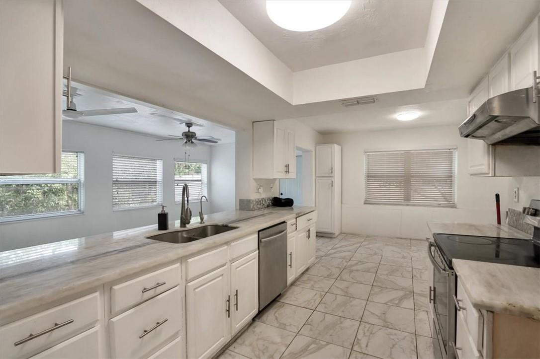 830 Southwest 50th Avenue Margate, FL 33068 - Photo 8 of 30 a large bathroom with a granite countertop double vanity sink a mirror and a bathtub