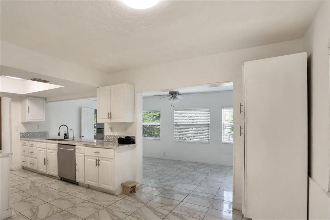 830 Southwest 50th Avenue Margate, FL 33068 - Photo 9 of 30 a kitchen with a white cabinets and window