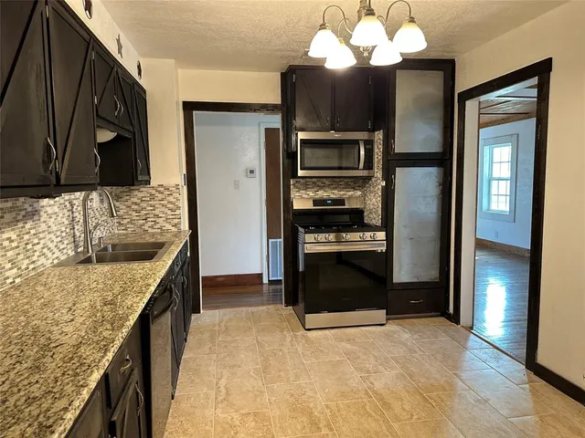 a kitchen with a sink stove and refrigerator