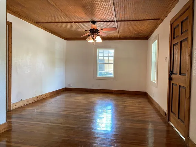 a view of a house with wooden floor and windows