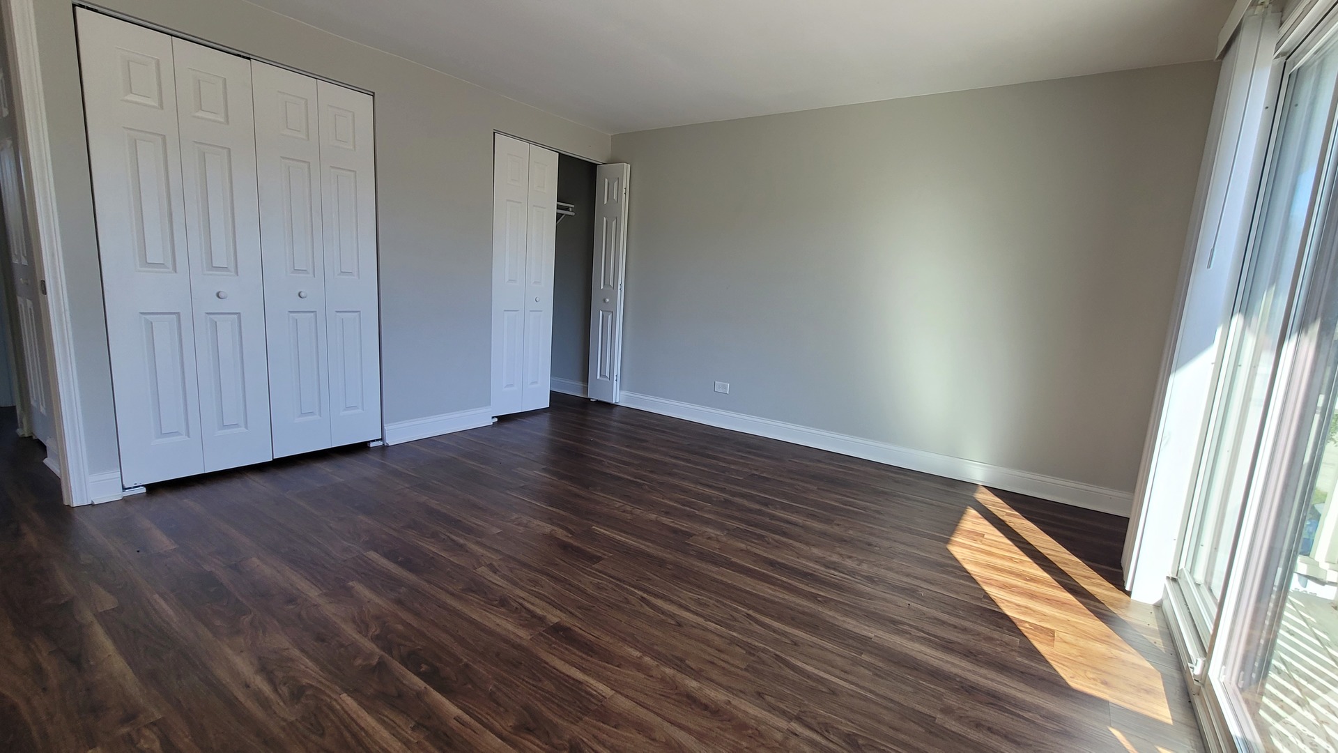 120 Cotuit Court, Unit 120 Schaumburg, IL 60193 - Photo 12 of 17 an empty room with wooden floor and windows