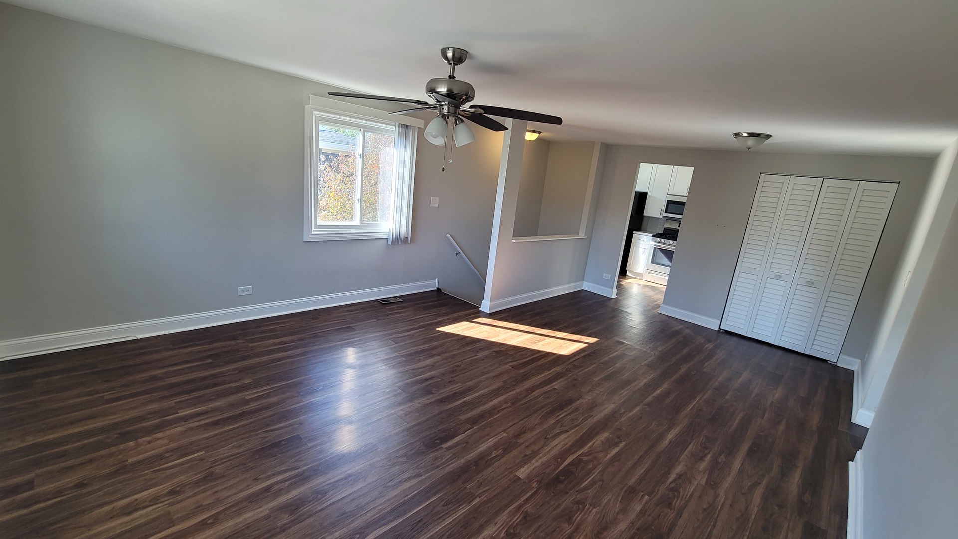 120 Cotuit Court, Unit 120 Schaumburg, IL 60193 - Photo 5 of 17 a view of empty room with wooden floor and window