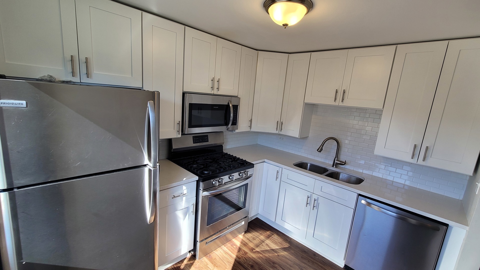120 Cotuit Court, Unit 120 Schaumburg, IL 60193 - Photo 9 of 17 a kitchen with stainless steel appliances granite countertop a refrigerator sink stove and white cabinets