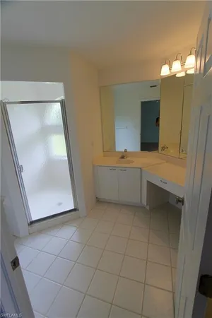 an empty room with a chandelier fan