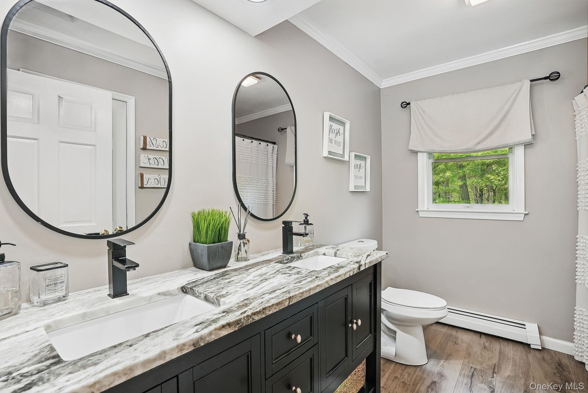 304 Church Road Putnam Valley, NY 10579 - Photo 25 of 50 Bathroom with a baseboard radiator, toilet, wood finished floors, double vanity, and crown molding