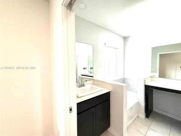 a bathroom with a double vanity sink toilet mirror and shower