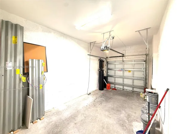 an empty room with wooden floor and window