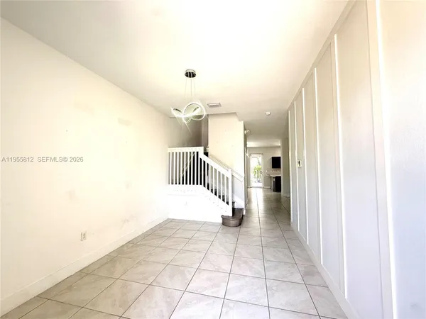 a view of a hallway with a bathroom