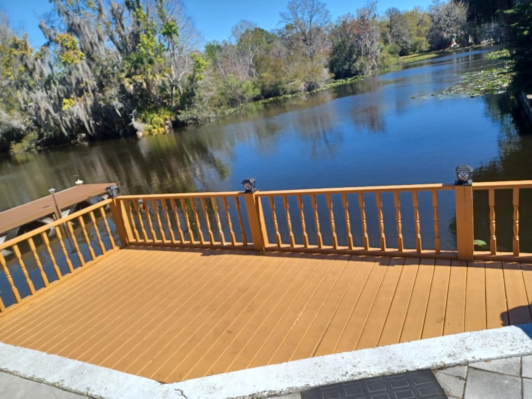 a view of wooden deck and lake