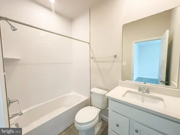 a bathroom with a sink toilet vanity and shower