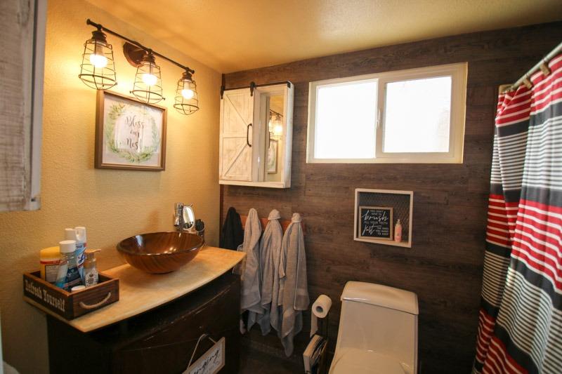8053 South Rio Avenue Reedley, CA 93654 - Photo 17 of 30 a bathroom with a toilet sink and mirror