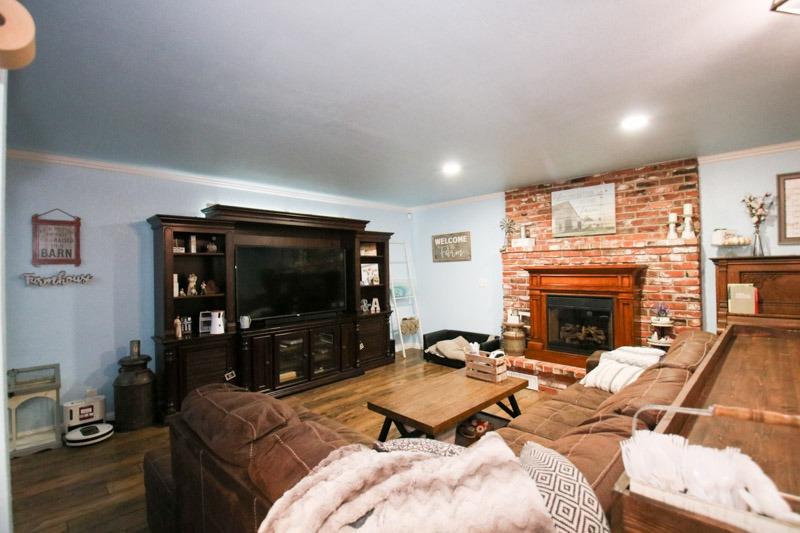 8053 South Rio Avenue Reedley, CA 93654 - Photo 6 of 30 a living room with furniture a flat screen tv and a fireplace